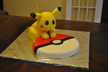 This is my second attempt at a sculpted cake.  I used the cake for 3D modeling recipes here on CakeCentral (vanilla for the Pokeball and chocolate for Pikachu), a mixture of homemade and Fondarific fondant, and a simplified swiss meringue buttercream.