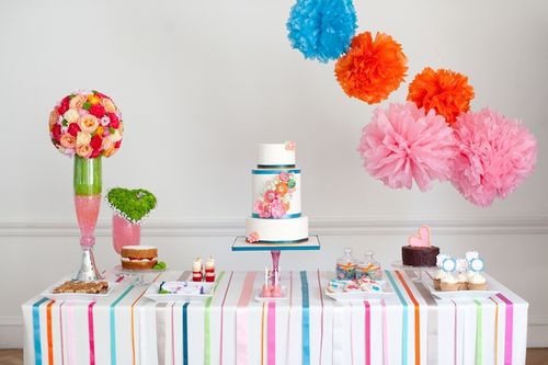 A dessert table for a styled 50's bridal shoot. Photo by http://www.carohutchingsphotography.com/  As featured on the Amy Atlas blog: http://blog.amyatlas.com/2012/04/colorful-floral-guest-dessert-feature/  Floral double barrel wedding cake with ranunuculus, peony and rose. Also on the table are a Victoria sponge, triple chocolate cake, trifle shots, apple pie cupcakes, milk chocolate, cake pops, sugar cookies and bakewell slices.  More photos and credits, www.facebook.com/sugaredsaffron
