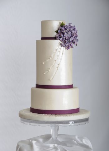 This cake was featured in the September issue of Cake Central Magazine, in the Less is More, Violet Charm section.  I am so honored and still excited to be asked to contribute to the magazine.  8", double 6" and 4" tiers covered in fondant, adorned with edible pearls and diamonds.  The little bouquet of flowers are gum paste.  TFL