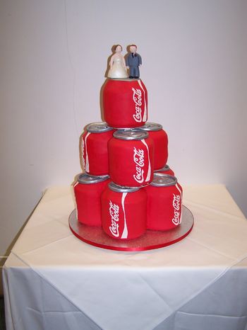 Wedding cake for a Coke addict. Covered in sugar paste, made of chocolate fudge cake, rainbow layered cake, carrot cake, lemon cake and rice crispie cake. Writing done with royal icing.