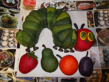 Very Hungry Caterpillar and fruits made from sponge cake and covered in marbled fondant.