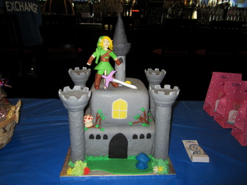 Legend of Zelda Cake.  Vanilla/Almond cake, fondant covered.  All items made of fondant, except for towers.  Covered in fondant, but they are the platic towers from Wilton castle set.