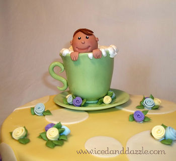 Baby shower cake to compliment the invitiation/party decor. Gumpaste teacup and baby boy. Cake is a 10" Carrot Cake with Very Vanilla Buttercream. I absolutely loved doing this cake and could barely bring myself to part with my cute little baby! TFL!
