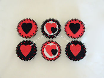 The customer asked for red and black cupcakes with hearts.