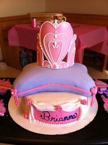 10' round chocolate cake with a 10' square pillow handcarved cake and a Fondant crown pipped with royal icing.