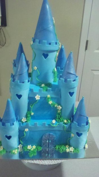 * Blue castle cake. Turrets are fondant/gumpaste mix. 8 inch square cake with 5 inch square on top, all vanilla. This took a really long time to make but I think it turned out really well.