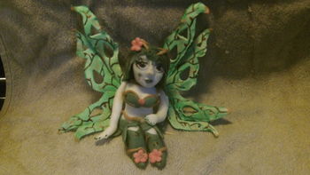 all 50/50 gumpaste and fondant.Airbrushed then hand painted wings with branches and petal dust highlights.