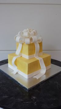 Both tiers were white almond velvet cake with IMBC icing.  Bow, ribbons, and ribbon border were a fondant/gumpaste mixture.
