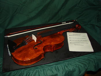 This cake is up for review by the PRCC. I wanted to give my son a meaningful "wow" cake for his 15th birthday. I chose the Viola since it's his instrument of choice in Advanced Orchestra. Everything is edible, even the strings. I enlarged a template to get the true sizing of a 16" viola. The neck was a PITA to make, the tuning pegs work and I had fun making it. There are several things I would do differently and some things I may need you all to point out. TIA. It's a Red Velvet Key Lime cake with IMBC.
