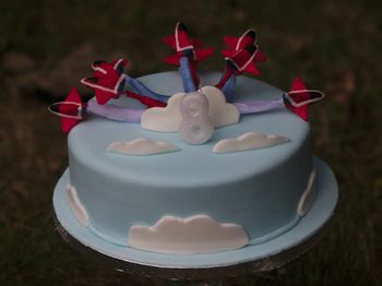 A Red Arrows birthday cake for my son.  We were on holiday so it's not as good as I'd hoped but he was happy with it.  I had to use ribbon for the vapour trails as couldn't source any candy floss in the right colours.  Modelling chocolate planes.
