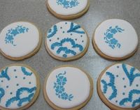 SOFT Royal Icing, WOW, I didn't believe it could be anything but rock hard. It is firm, smooth, easy to work on top of, yet has a non-crunchy bite. Ok so my outline isn't perfect, but it's better.  My hand embroidery isn't neat, but the stencil is superb!