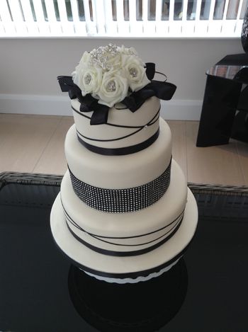 ivory and black 3 tier wedding cake ,top tier zesty lemon,middle tier chocolate and bottom tier Victoria sandwich