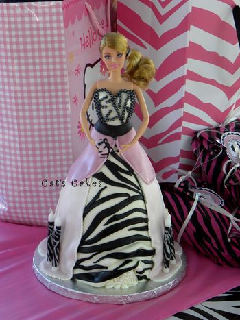 Zebra striped marble cake filled with chocolate brownie buttercream and vanilla buttercream and covered in MMF and candy pearls.