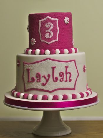 Laylah's Birthday Cake. Vanilla pink ombre cake with vanilla buttercream on the bottom and chocolate cake with chocolate buttercream on the top. White chocolate ganache and sugarpaste to cover.