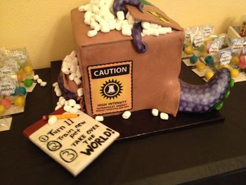 This was a cake for my son's 11th birthday.  He was having a mad scientist party, and we decided this might be a good way to represent the theme.  He's ordered a new pet to take over the world!  WASC (which is his favorite), with a standard american buttercream. The box sides and top are modeling chocolate (first time working with it--pretty intriguing), and the tentacles are fondant.  Packing peanuts are marshmallows, obviously.  Images are on edible paper/edible ink.  Thanks for looking!