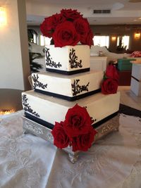 Square Wedding Cake- With rose topper.  But the Groom had another vision for this.....