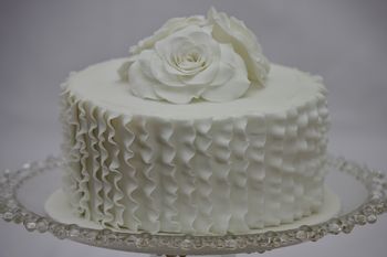 Roses and ruffles. Chocolate cake filled with chocolate orange buttercream and decorated with sugarpaste roses and vertical ruffles.