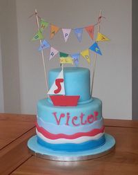 Nautical themed cake. Boat made from gumpaste, everything else from fondant. Bunting made of paper.