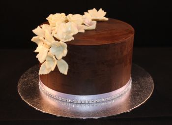 This was my first attempt at using the upside down method to achieve sharp edges on a cake with ganache.  It was also my first try at white modelling chocolate which I have used to make the flowers.  Overall pretty pleased with the outcome.