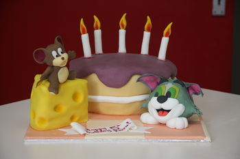 A cake for a 5 year old that LOVES Tom and Jerry   The cheese and cake are both vanilla sponge with vanilla frosting, figures and candles are half and half, ears on tom are flower paste along with the banner.