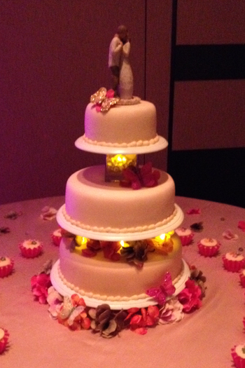 Showing the cake again when the lighting in the room was dimmed.  You can see the lights in between the tiers.