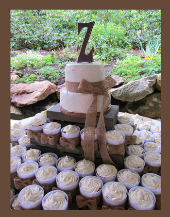 I call these a more "civilized" cupcake - eaten with a fork.  Straight sided plastic cups can be easily decorated with ribbon or paper cutouts or silk flowers.  Shown below with burlap bands and bows.