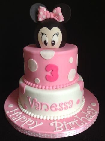 Minnie Mouse is covered on a styrofoam ball. Top tier is rice krispies, bottom tier is chocolate cake with chocolate buttercream.