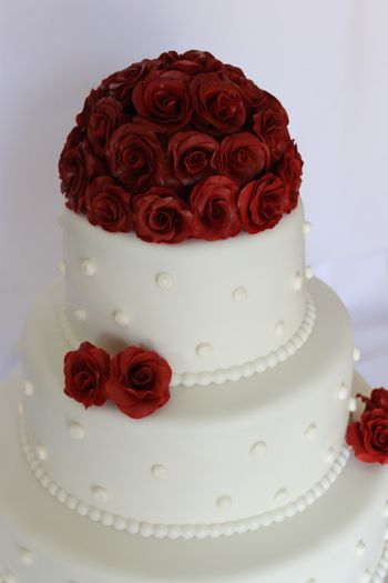 My first wedding cake! Red roses with ball border and some buttercream dots on each tier! Very proud :)
